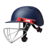 The Gunn & Moore Purist Geo II Navy Helmet features a Geo steel grille, black adjustable straps, a red GM logo sticker, air vents, and a chin protector for comfort and safety.