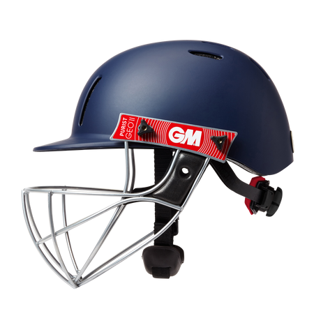 The Gunn & Moore Purist Geo II Navy Helmet features a Geo steel grille, black adjustable straps, a red GM logo sticker, air vents, and a chin protector for comfort and safety.