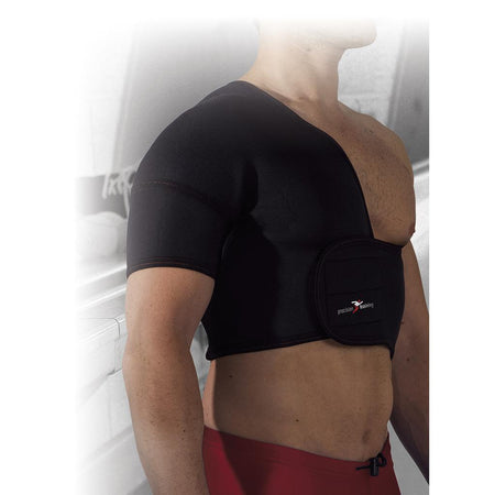 A person wears the Precision Training Neoprene Half Shoulder Support (Right) with adjustable straps on their right shoulder, chest exposed, and red shorts visible. Blurred gym equipment in the background suggests use for shoulder relief.