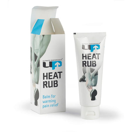 A white tube and its box, both displaying the Ultimate Performance logo, are labeled Reydon Sports Ultimate Performance Heat Rub 100ml. The packaging features hands rubbing a leg and states: "Balm for warming pain relief; ideal as a sore muscle cream.