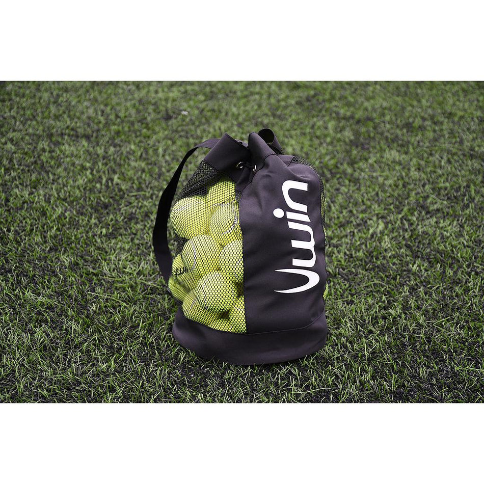 The Uwin Small Ball Carry Bag by Uwin, featuring white lettering and a convenient handle, holds yellow tennis balls in its black mesh design—perfect for easy storage on the field before your next match.