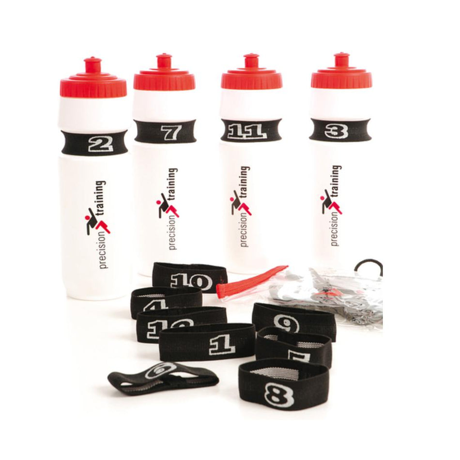 Four white water bottles with red lids, each marked by a Reydon Sports Elasticated Bottle Number. Several extra numbered bands and a whistle lie in front, all branded with Reydon Sports in black and red text.