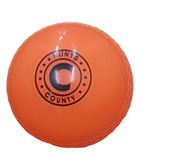 The Hunts County Flik PVC Cricket Ball (Orange), featuring the Hunts County logo and a bold 'C' on the center, is ideal for use with plastic cricket bats or in cricket sets, shown against a white background.