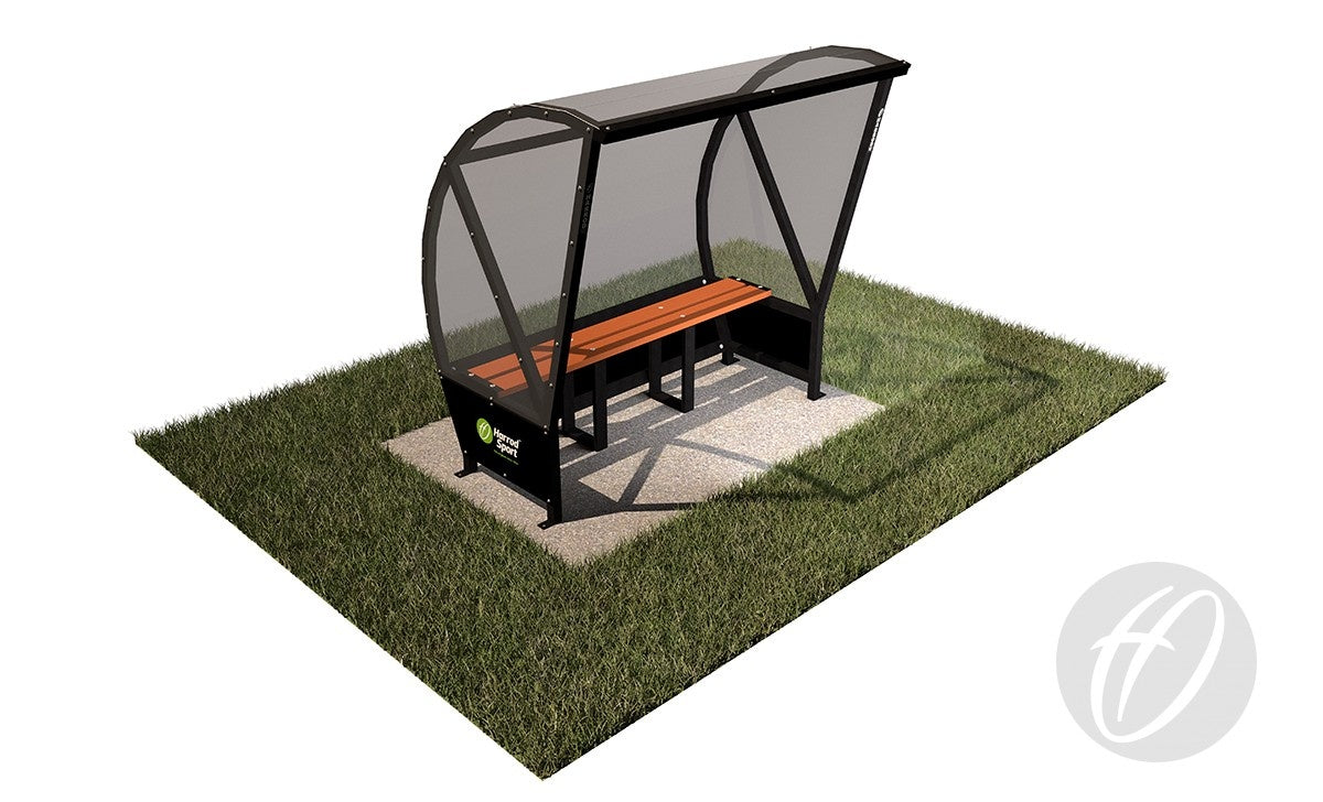 The Harrod Sport Panoramic Team Shelter - 4M features a transparent polycarbonate roof, black aluminium frame, and wooden bench, all set on a compact concrete pad with surrounding grass for modern outdoor appeal.