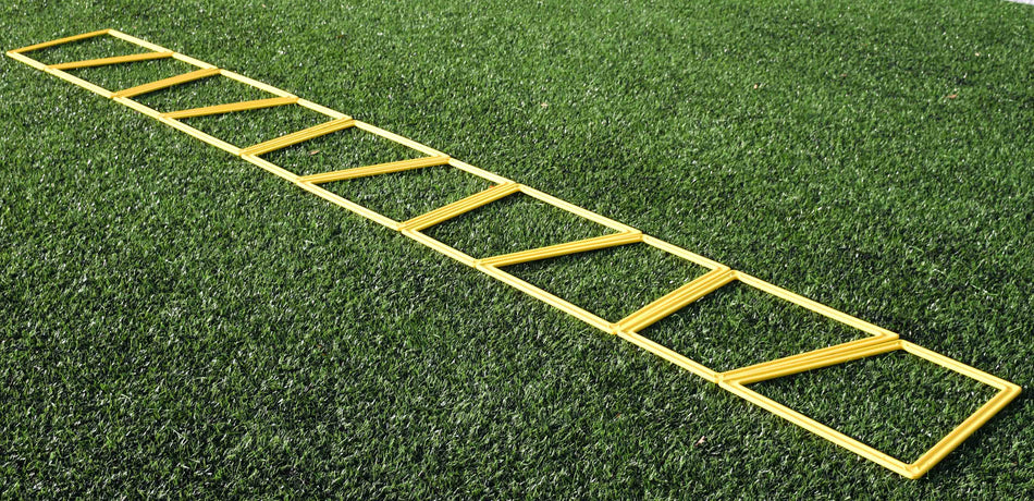 The Precision Training Precision Poly Grid System (set of 10) in yellow lies flat on green artificial grass, ideal for agility training and footwork drills.