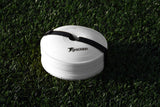 A stack of Precision Pro Near Flat Markers (set of 40) by Precision Training, secured with a black strap, rests on green artificial grass. The top white marker features the Precision Training logo and branding.