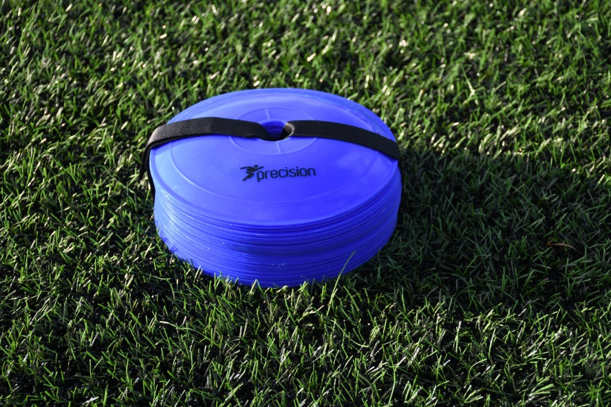 A stack of blue Precision Pro Near Flat Markers by Precision Training, held together with a black strap, rests on green artificial grass—ideal as soccer training markers. Set includes 40 low profile cones.