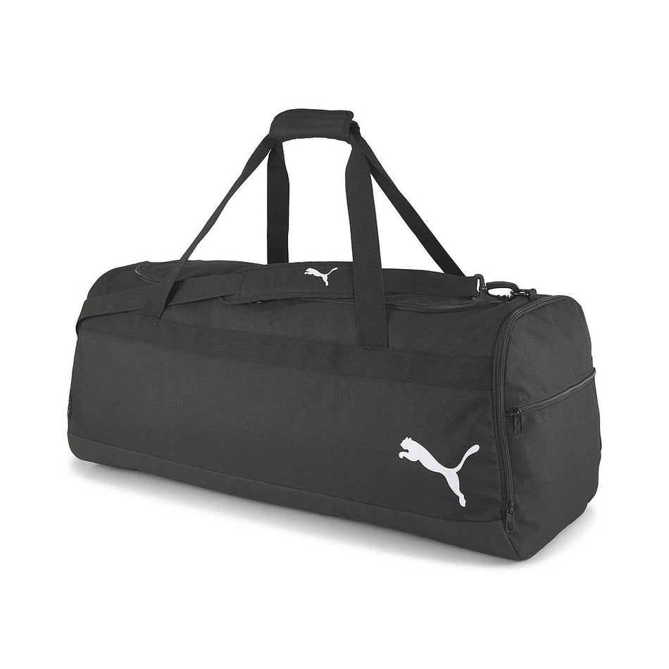 A Puma Team Goal 23 Wheel Teambag - XL, black with two handles, a shoulder strap, and the white Puma logo on the side, is shown against a white background.