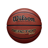 The Wilson Reaction Pro Basketball by Wilson features a composite cover, standard pebble texture, and black and gold branding. Designed for indoor/outdoor play, it is shown photographed against a white background.