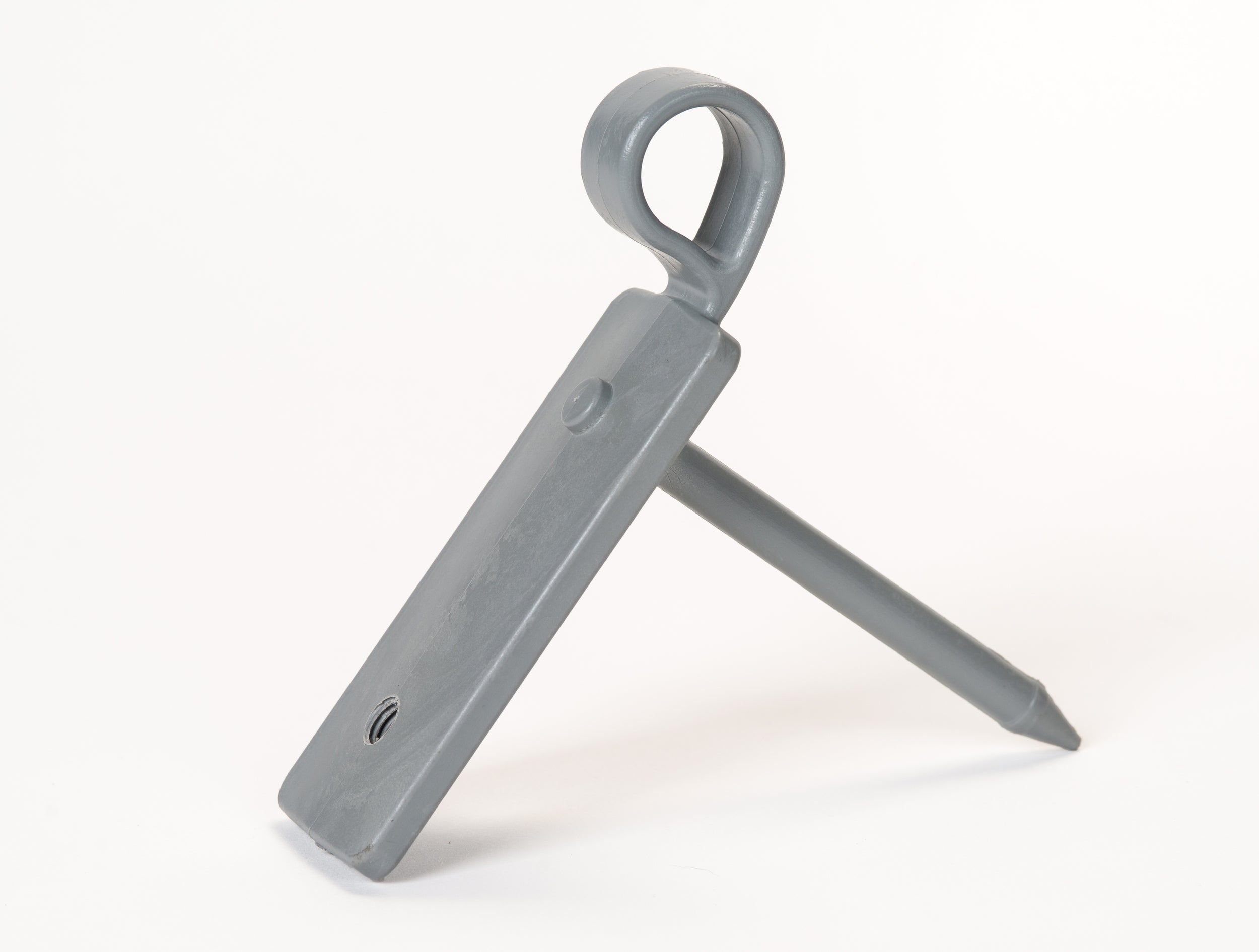 The Fusion Multi-stump Spike by Fusion, featuring a gray plastic rectangular body with a circular loop at one end and mounted on a pointed fibreglass spike, is displayed against a white background.