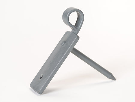 The Fusion Multi-stump Spike by Fusion, featuring a gray plastic rectangular body with a circular loop at one end and mounted on a pointed fibreglass spike, is displayed against a white background.