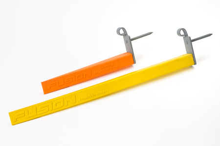 Two rectangular Fusion Multi-stump Spikes: one orange (the shorter FUSION Shorty) and one yellow (ideal for hard ground with a durable fibreglass spike). Both feature attached gray stump spikes.