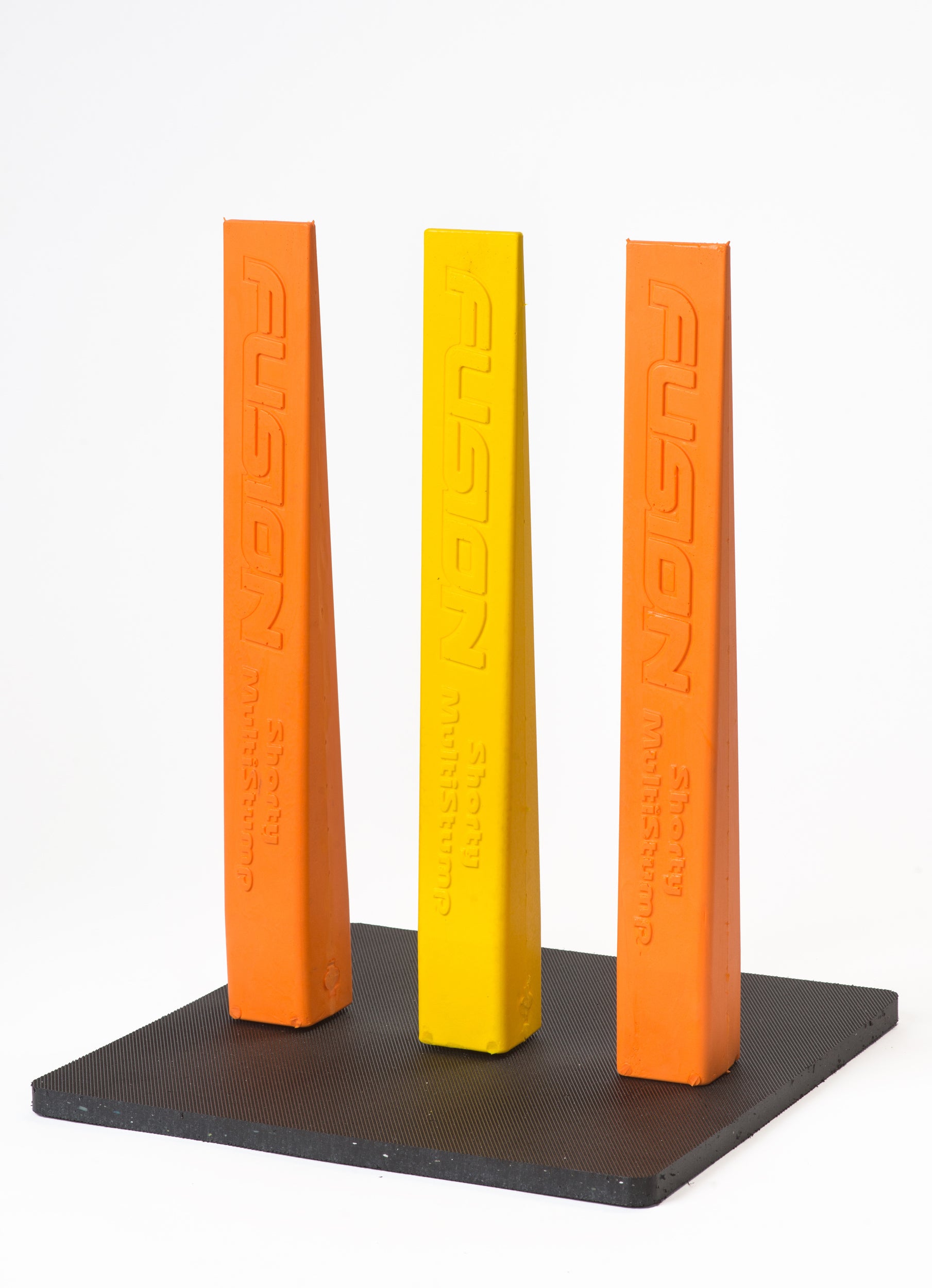 Three tall, triangular Fusion stumps—two orange, one yellow—stand upright on a black Fusion Multi-Stump All Weather Base. Each stump is labeled “FUSION” vertically, perfect for hard wicket or all-weather cricket setups.