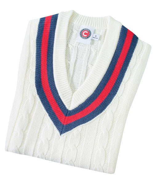 The Hunts County Trimmed Cricket Sweater is a folded white sweater with a deep V-neck and navy blue and red stripes along the neckline.