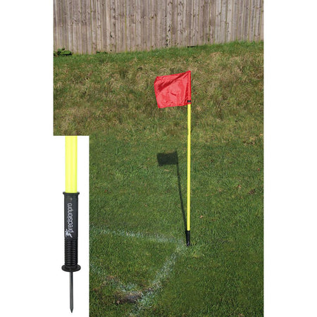 A set of four Precision "Sprung" Corner Posts by Precision Training in fluorescent yellow stands at the corner of a grassy soccer field; an inset highlights the durable, weatherproof black spiked base.