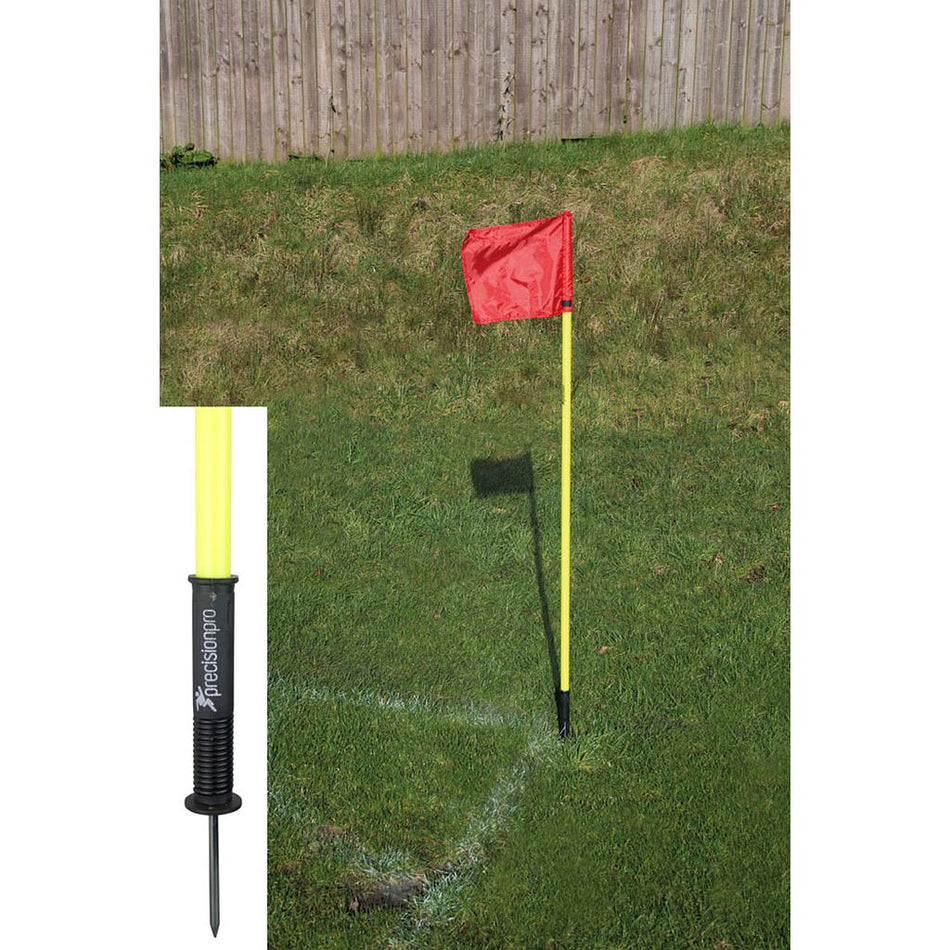 A set of four Precision "Sprung" Corner Posts by Precision Training in fluorescent yellow stands at the corner of a grassy soccer field; an inset highlights the durable, weatherproof black spiked base.