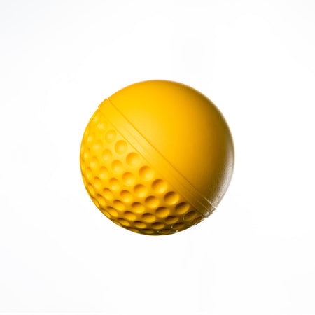 The Swinga Technique Ball by Swinga features a yellow design with one smooth half and one dimpled half, resembling a golf ball—ideal for cricket batting practice and training, shown isolated on a white background.