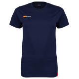 The Grays Ladies Tangent Tee Shirt is a navy blue short-sleeve top in soft organic cotton jersey, featuring a small orange and white logo on the left chest and a red tag near the hem, shown on a white background.