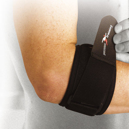A person wears the Precision Neoprene Tennis Elbow Strap Universal by Precision Training, with the brand's name visible on the black strap. The focus is on their arm and the strap, while the background appears blurred.