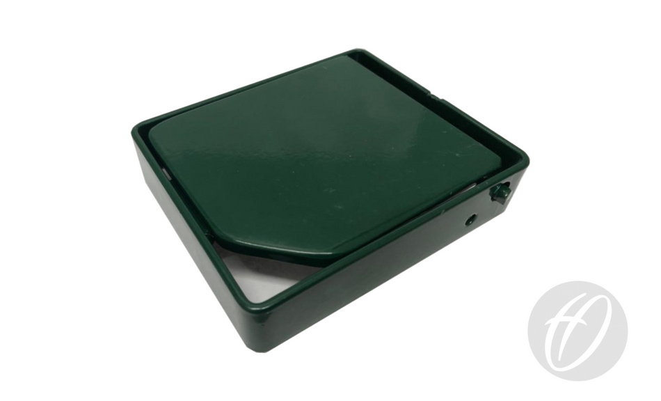 A dark green, rectangular Harrod Sport S8 Tennis Socket Raiser 25MM with a hinged lid, slightly open to show its white interior, sits on a white surface featuring a faint gray logo in the bottom right corner.