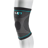 The Reydon Sports Ultimate Performance Ultimate Compression Elastic Knee Support in black and gray with turquoise accents features flexible, breathable fabric and a logo on the upper band—ideal for knee injury recovery.
