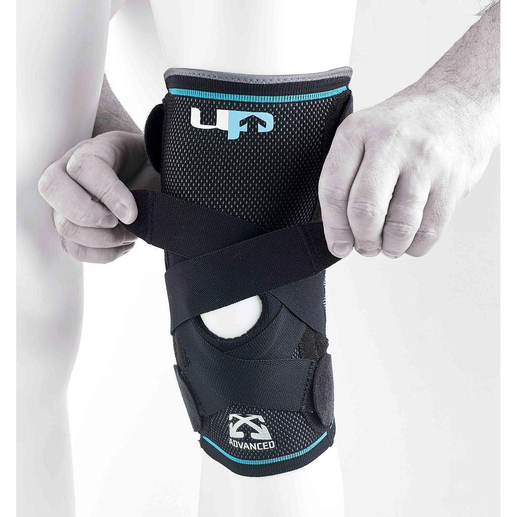 A person adjusts the Reydon Sports Ultimate Performance Advanced Ultimate Compression Knee Support, a black brace with straps and an open patella design, offering stability, comfort, and visible branding.
