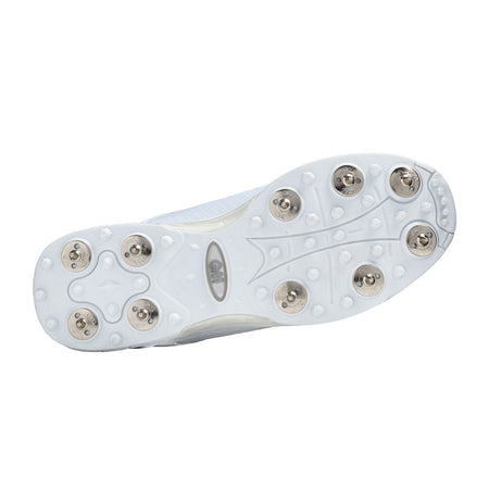 The image shows the bottom of the Gunn & Moore Icon Spike Junior by Gunn & Moore, a white shoe with twelve metal spikes for enhanced grip on soft surfaces—perfect for young athletes wanting lightweight sports footwear.